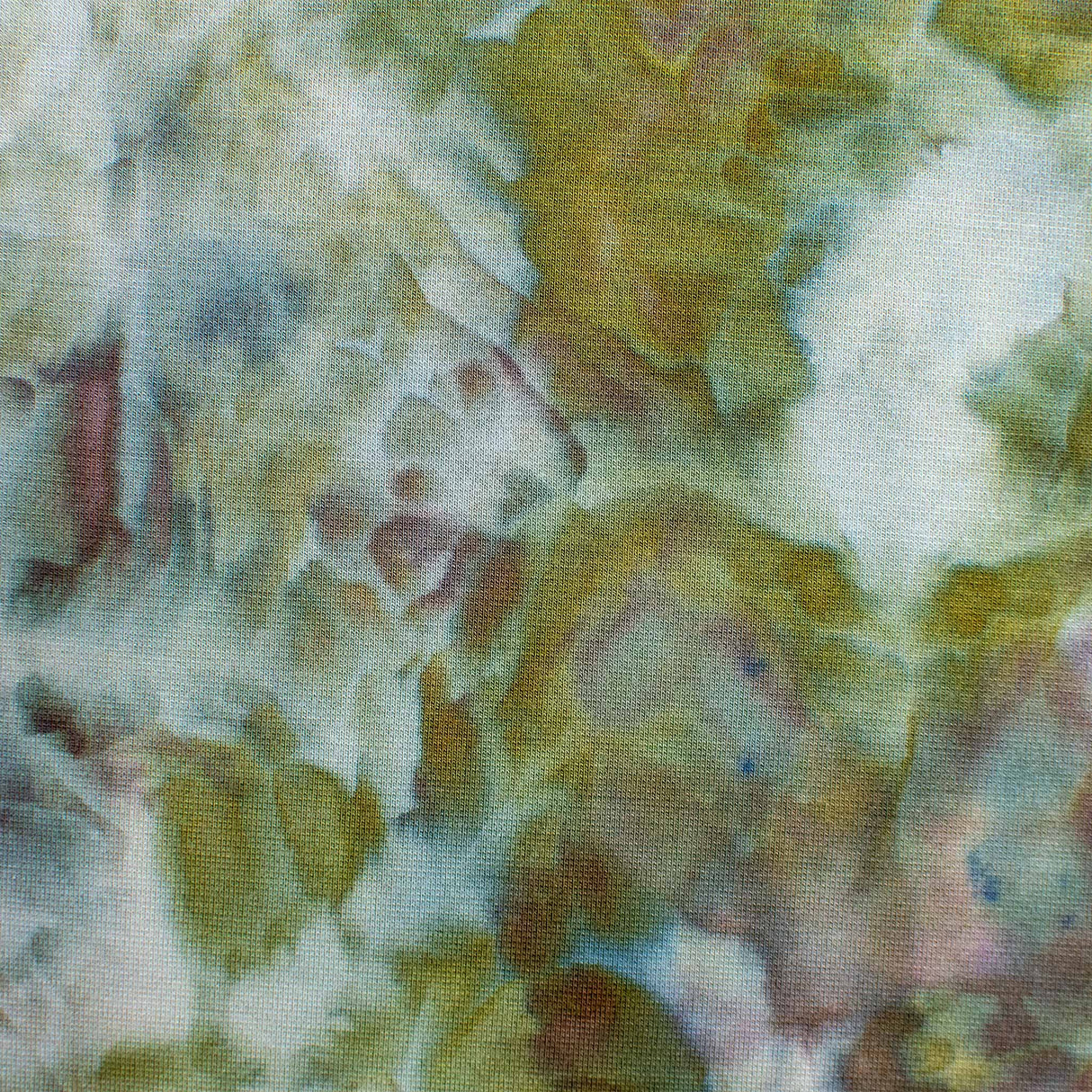 An artistic ice-dyed dress with a gentle color palette, featuring smudged impressions of olive, mauve, and earthy tones for a natural look.