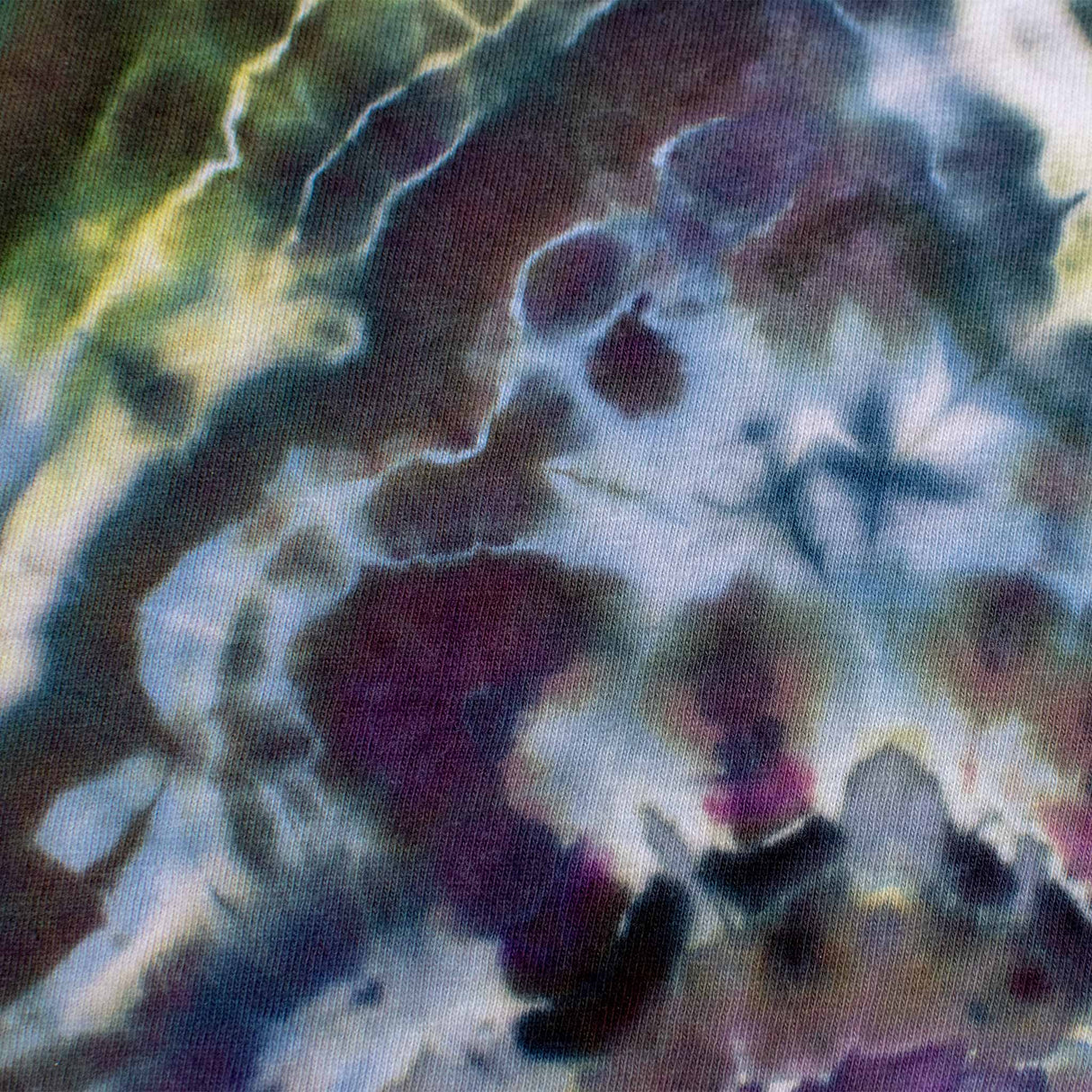 Vibrant streaks of lavender, cerulean, and jade converge in a geode-inspired ice dye pattern on this t-shirt, showcasing 'Dinkey Creek' screen printing.