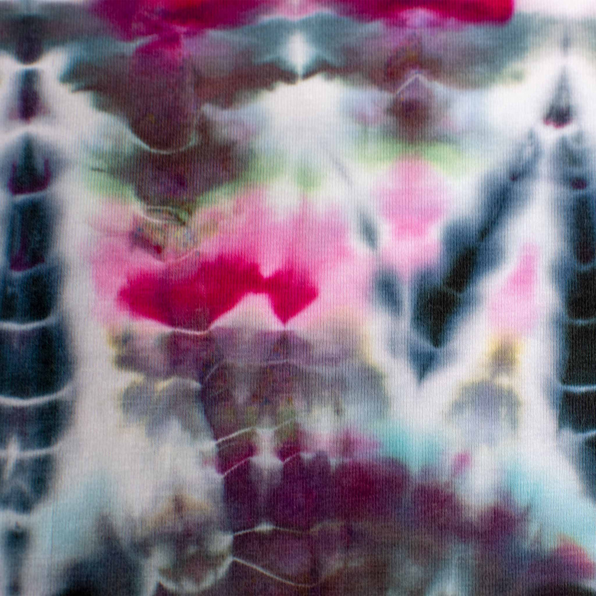 An eye-catching, elastic bandeau top with a psychedelic tie-dye print in vivid pink, deep blue, and dark gray hues.