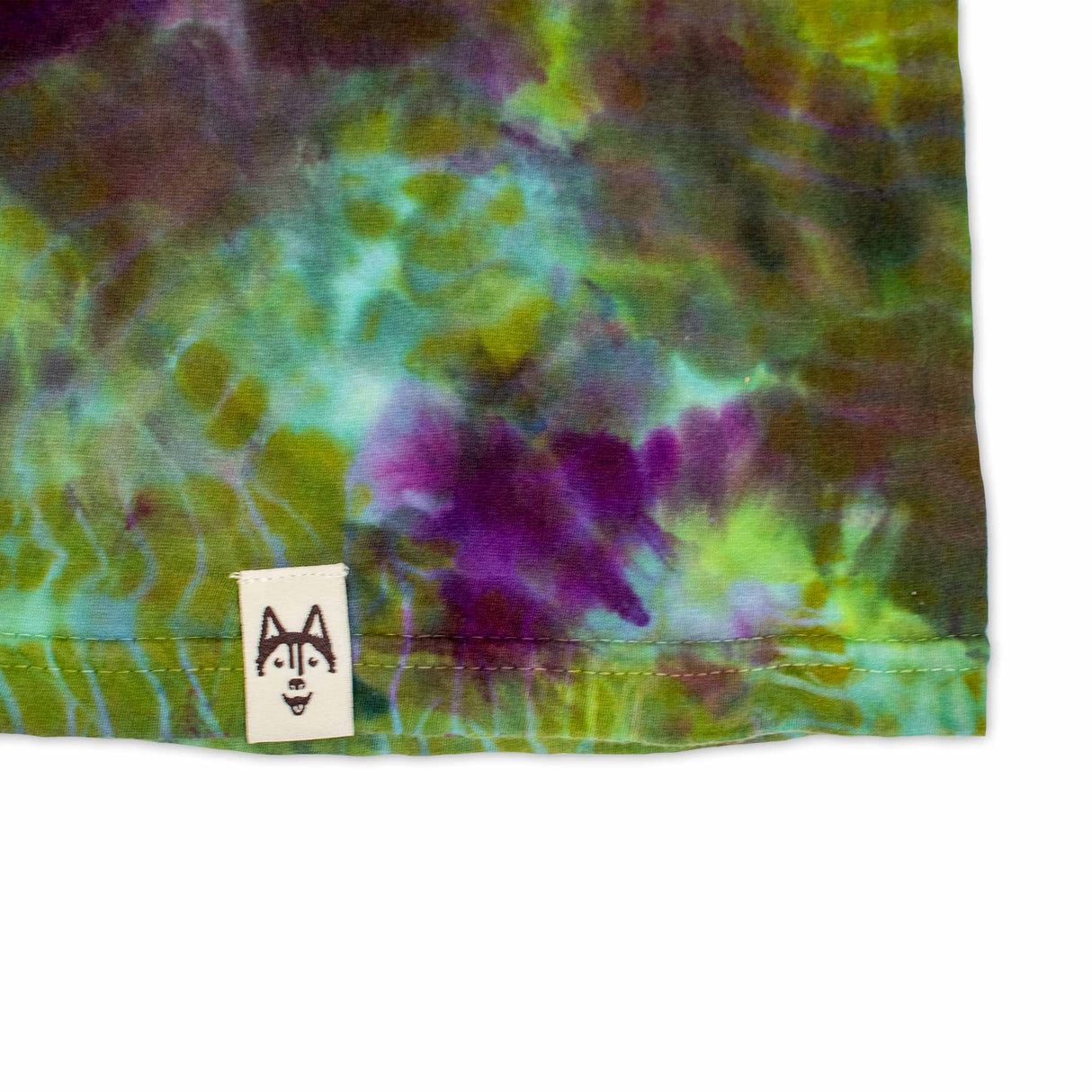 A mesmerizing tie-dye long sleeve shirt, with a fusion of emerald green, lavender, and burgundy hues.