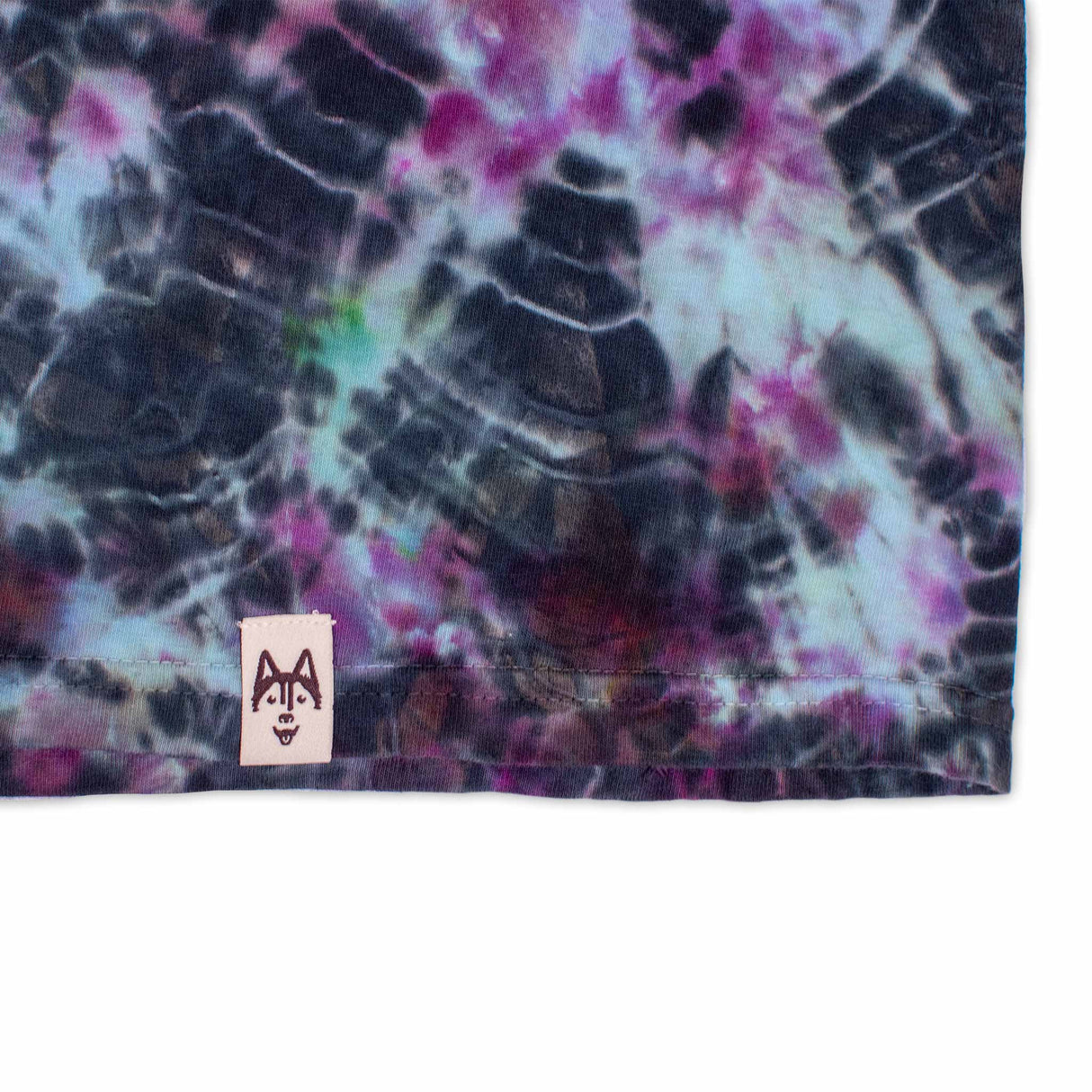 Long-sleeved t-shirt featuring a dual tie-dye technique, with intricate patterns of black crackle and bursts of pink and aqua blue, creating a visually striking and unique design.