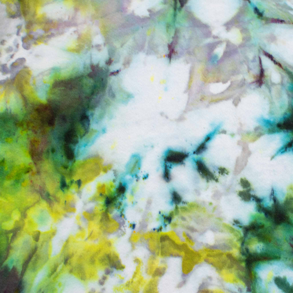 A pair of artistic ice-dyed sweatpants, with a kaleidoscopic effect of electric green, deep violet, and sky blue colors.