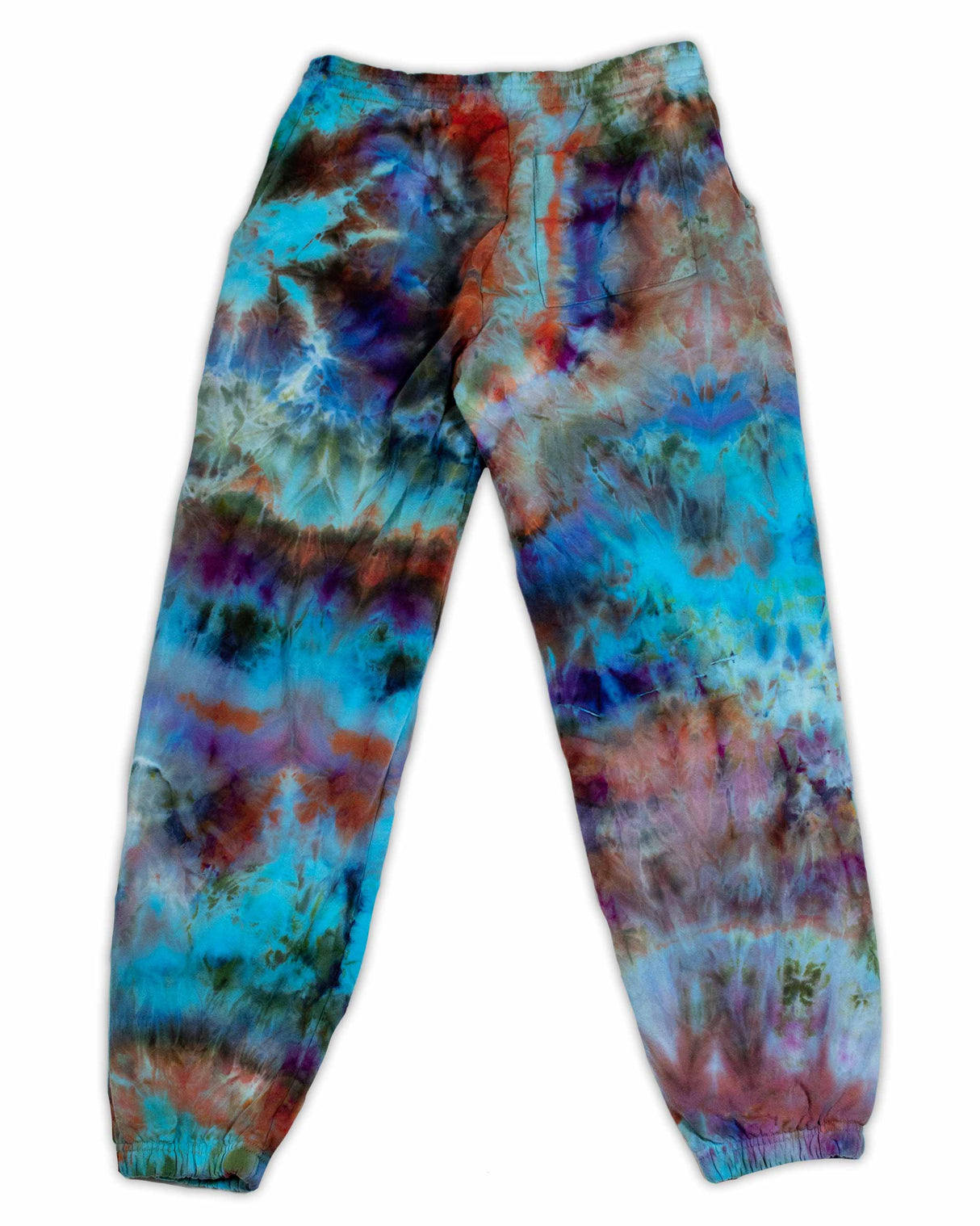 A pair of artistic ice-dyed sweatpants, with a dynamic mix of cobalt, fiery orange, and deep lilac, evoking a sense of abstract expressionism.