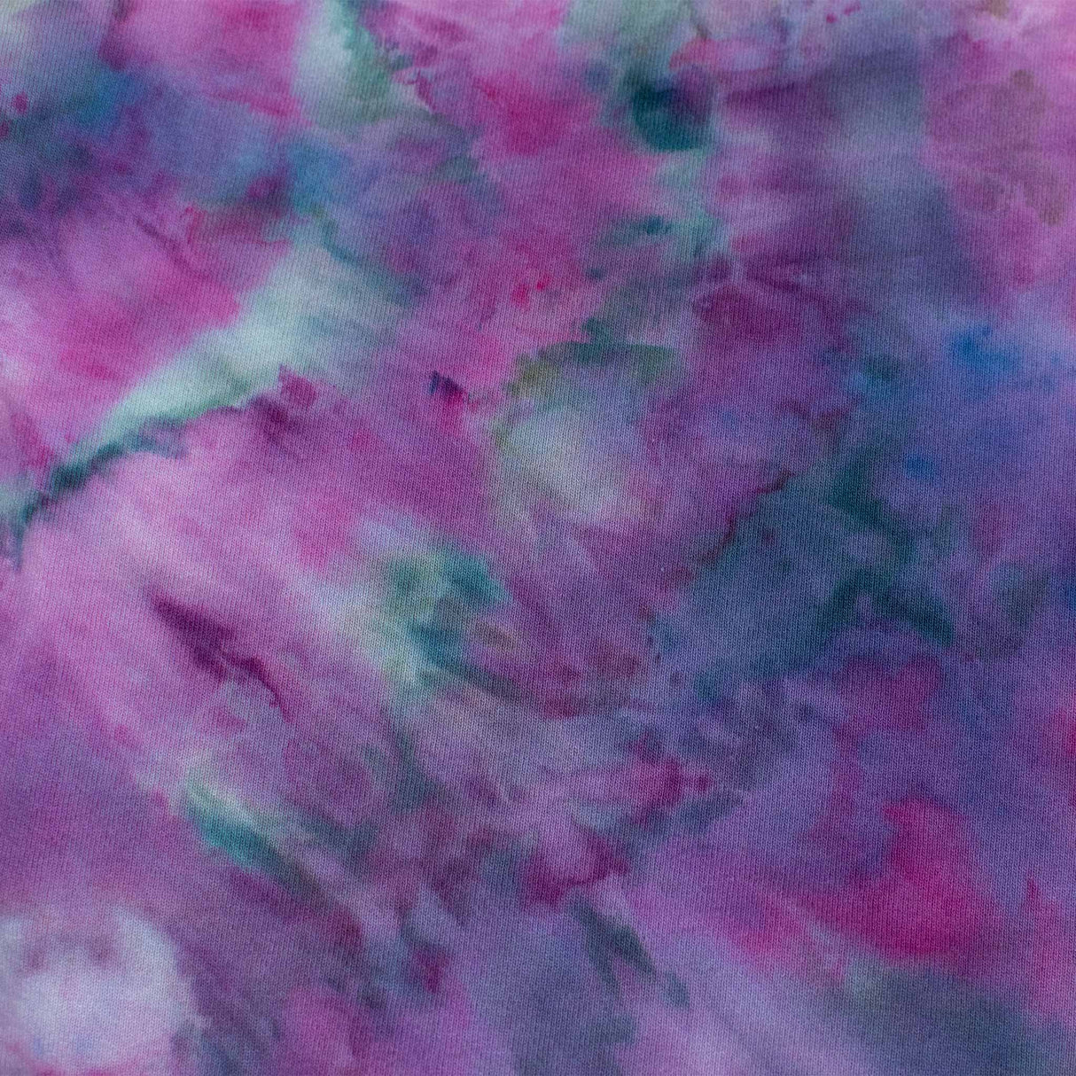 A tie-dye sweatshirt showcases a vibrant pattern of purples and blues, with colors merging fluidly. The ribbed cuffs and hem indicate a cozy and comfortable design.