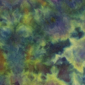 The 'Dinkey Creek' logo is subtly placed on a t-shirt with a mottled ice dye pattern in shades of green and purple, mimicking the natural variations of foliage. Features a unique 'Dinkey Creek' screen print design.